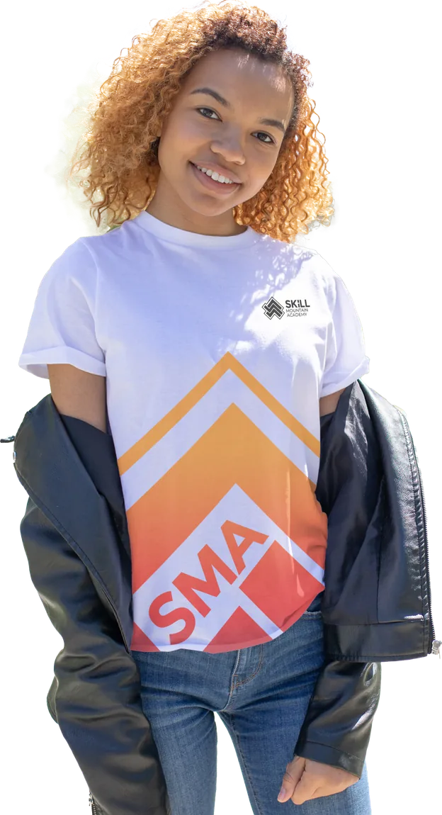 A smiling learner wearing a Skill Mountain Academy t-shirt